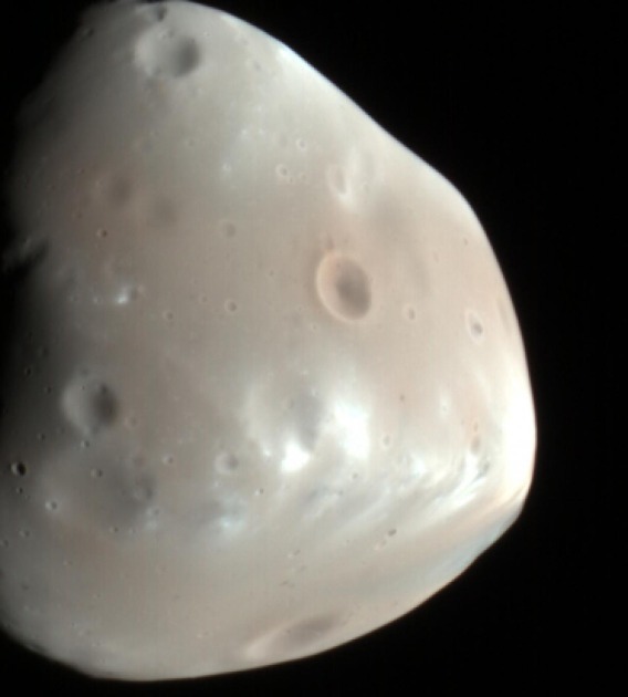 The HiRISE camera took two color-enhanced views of Deimos on Feb. 21, 2009. The sun illuminated from the right in this image. The HiRISE camera resolved surface features as small as 60 meters across.