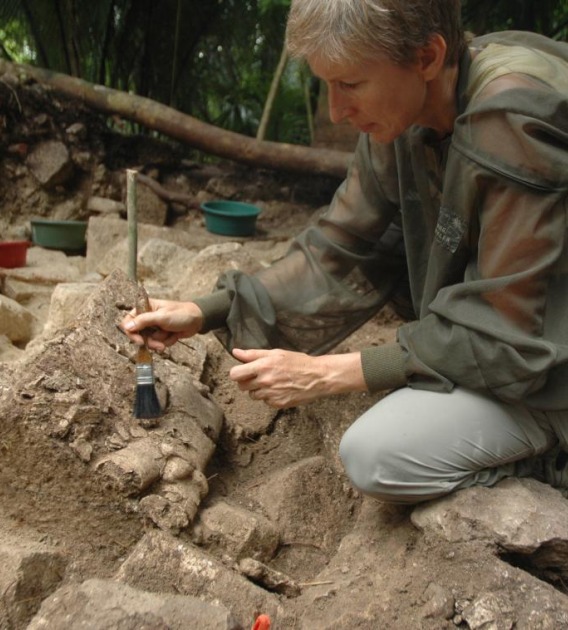 UA anthropology professor Daniela Triadan excavates the collapsed facade of the royal palace of Ceibal, which was burned during the Classic Maya collapse in the ninth century.(Photo: Takeshi Inomata)